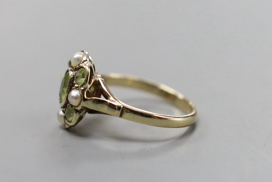 An early 20th century yellow metal, peridot and split pearl cluster set dress ring, size N, gross weight 3 grams.